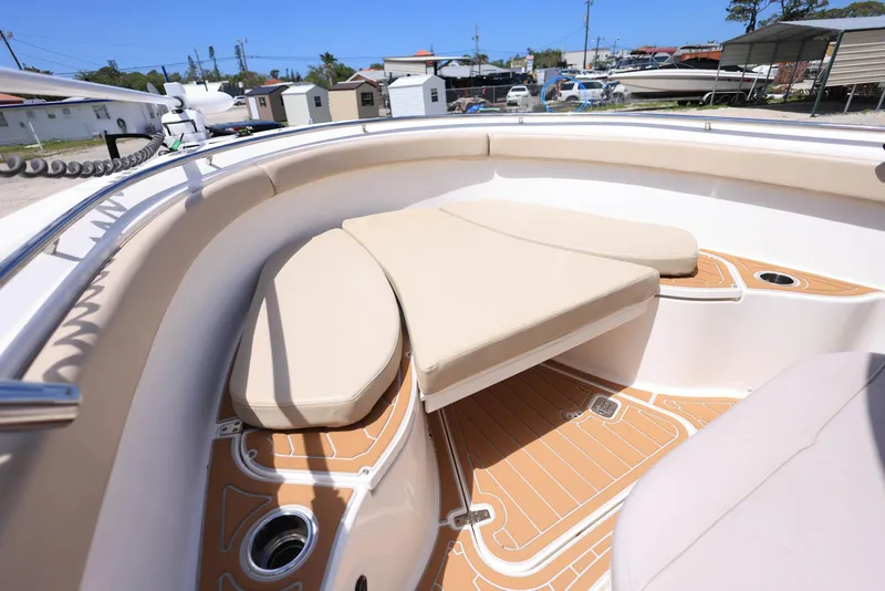 Slide: The Image of 2015 Pursuit S 280 Sport boat interior with beige seating and teak-style flooring. - 29