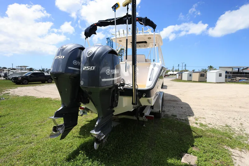Slide: The Image of 2015 Pursuit S 280 Sport boat with twin Yamaha 250 engines on grassy area. - 3
