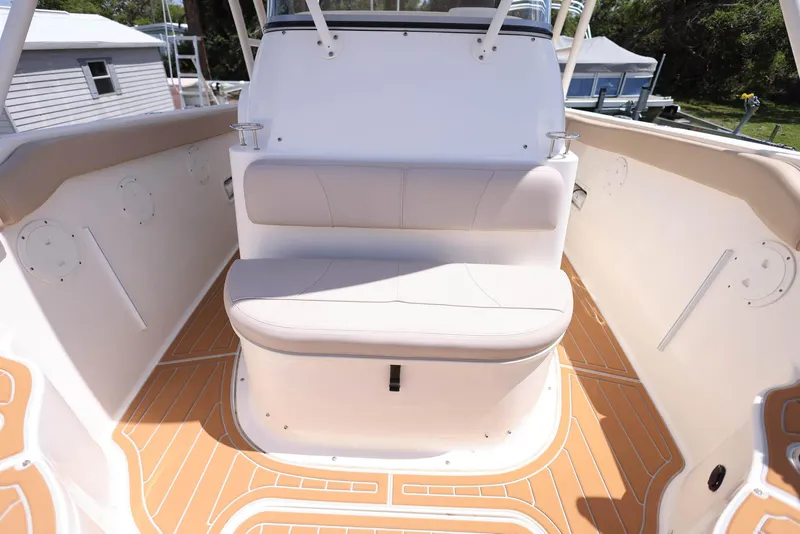 Slide: The Image of 2015 Pursuit S 280 Sport boat interior with cushioned seating and teak flooring. - 33
