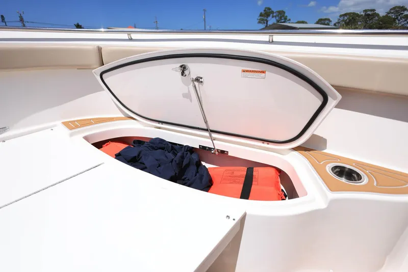 Slide: The Image of 2015 Pursuit S 280 Sport boat storage compartment with life jackets and gear. - 36