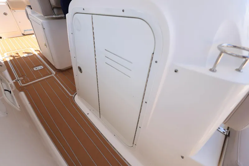 Slide: The Image of 2015 Pursuit S 280 Sport boat deck with storage compartment. - 38
