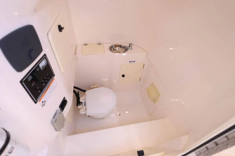 Slide: The Image of 2015 Pursuit S 280 Sport boat interior with toilet and sink. - 39