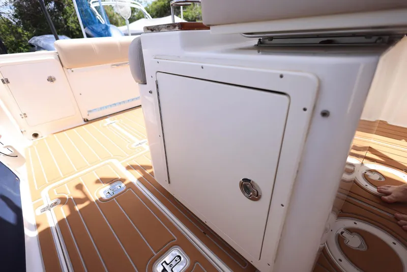 Slide: The Image of 2015 Pursuit S 280 Sport boat interior with storage compartment and teak flooring. - 40