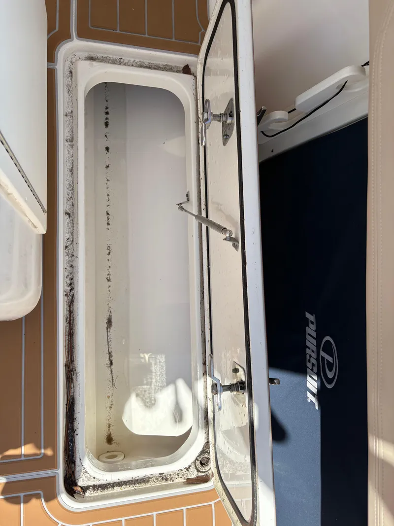 Slide: The Image of Open storage compartment on 2015 Pursuit S 280 Sport boat. - 46