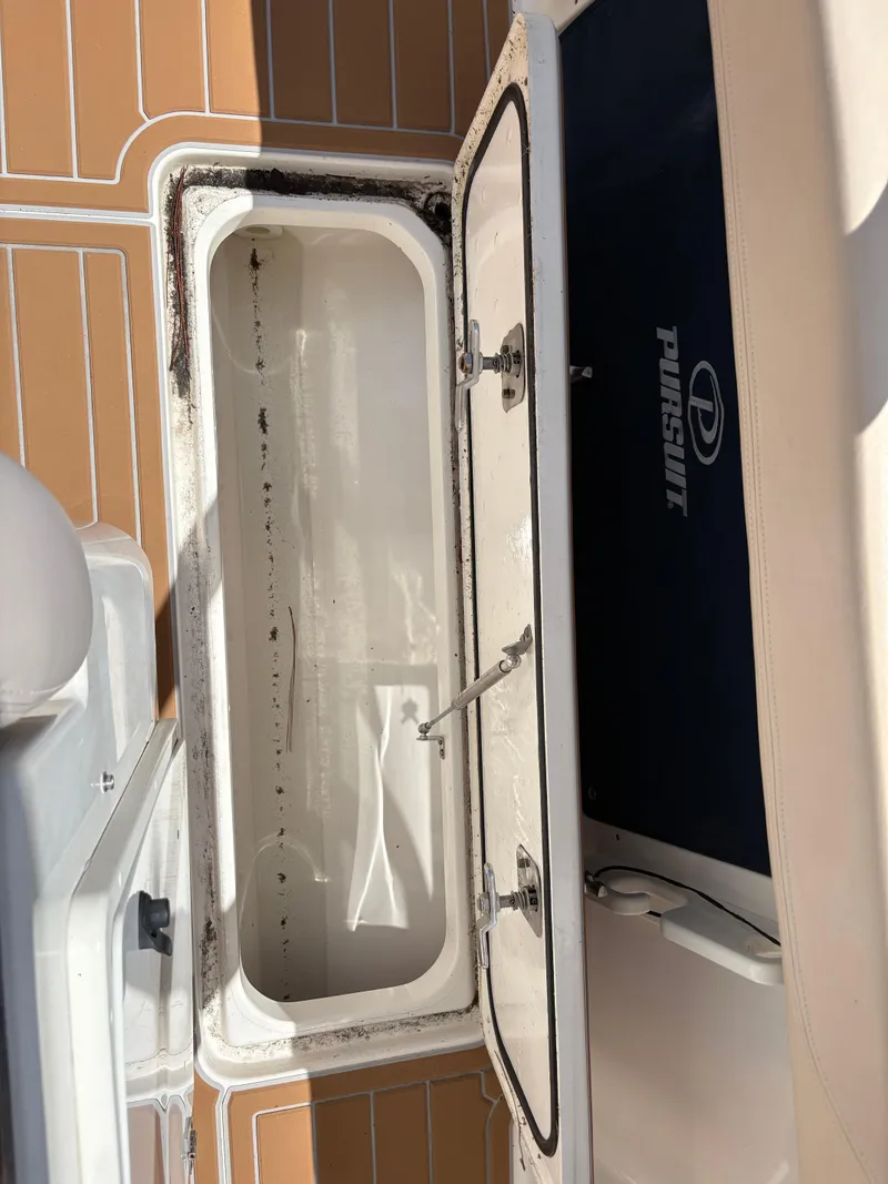 Slide: The Image of Open storage compartment on 2015 Pursuit S 280 Sport boat deck. - 47