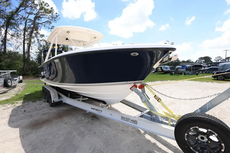 Slide: The Image of 2015 Pursuit S 280 Sport boat on trailer, parked outdoors under blue sky. - 5
