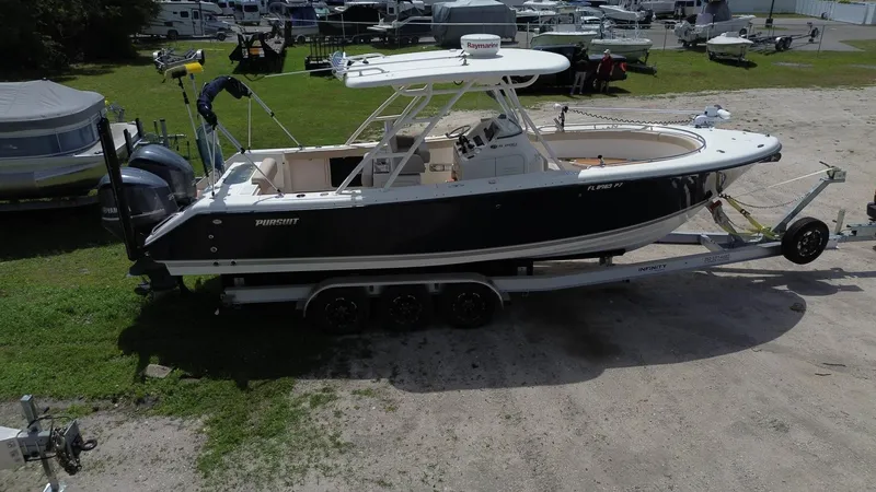 Slide: The Image of 2015 Pursuit S 280 Sport boat on trailer in outdoor setting. - 9