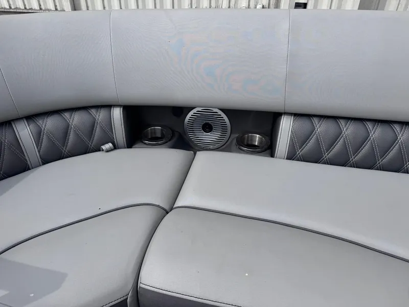 Slide: The Image of 2022 Bennington LX24FB boat interior with gray cushioned seating and cup holders. - 11