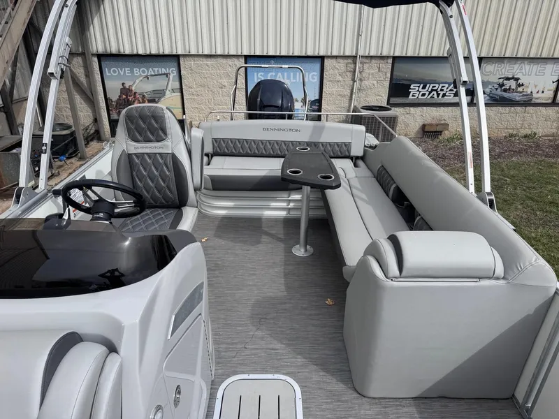 Slide: The Image of 2022 Bennington LX24FB pontoon boat interior with gray seating and steering console. - 13