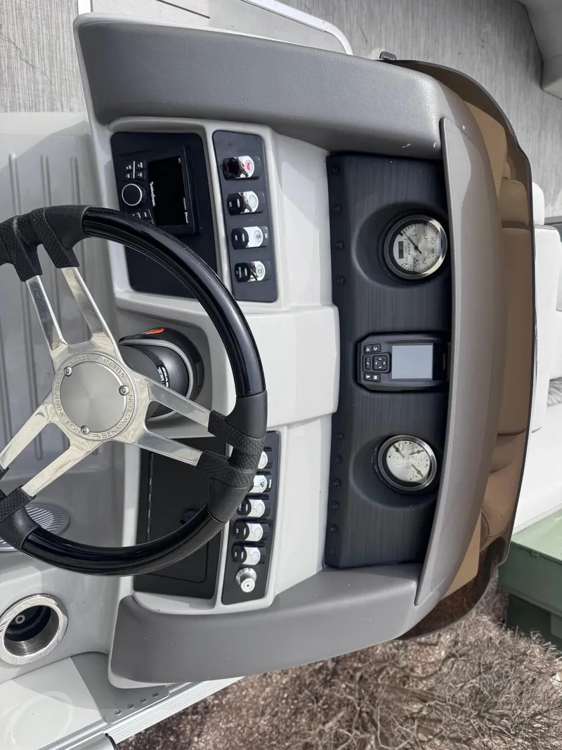 Slide: The Image of 2022 Bennington LX24FB boat dashboard with steering wheel and control panel. - 15