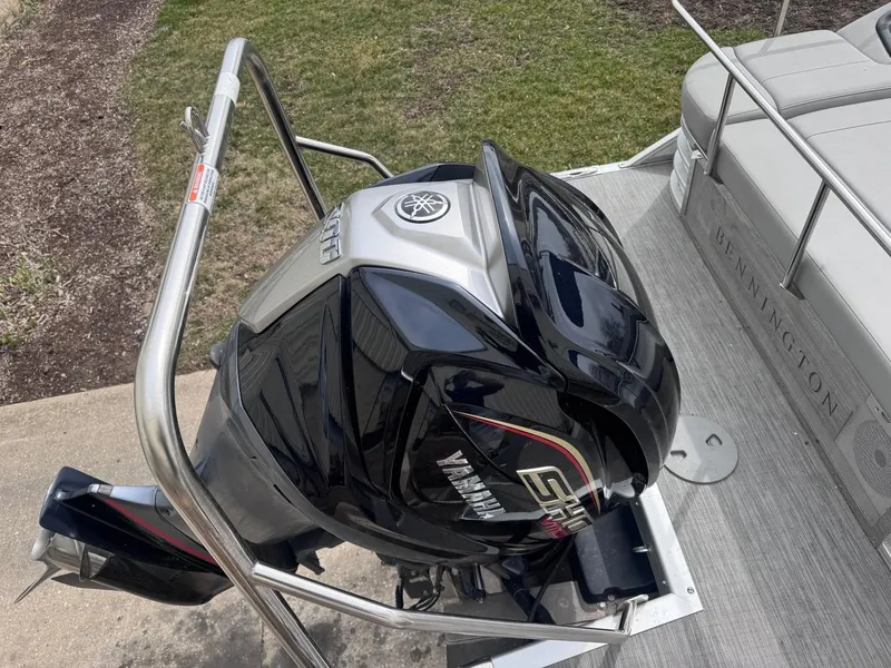 Slide: The Image of 2022 Bennington LX24FB boat with Yamaha outboard motor, docked on a sunny day. - 5