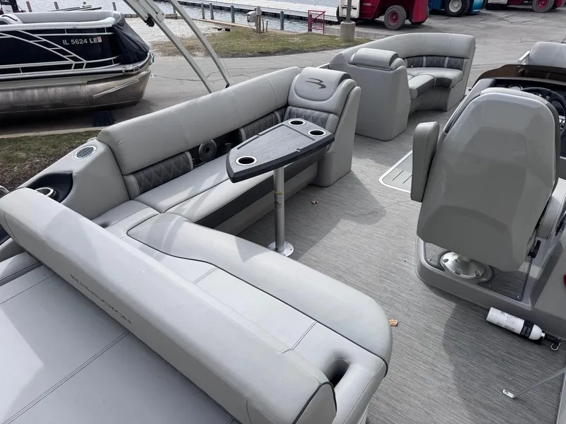 Slide: The Image of 2022 Bennington LX24FB pontoon boat interior with gray seating and table. - 7