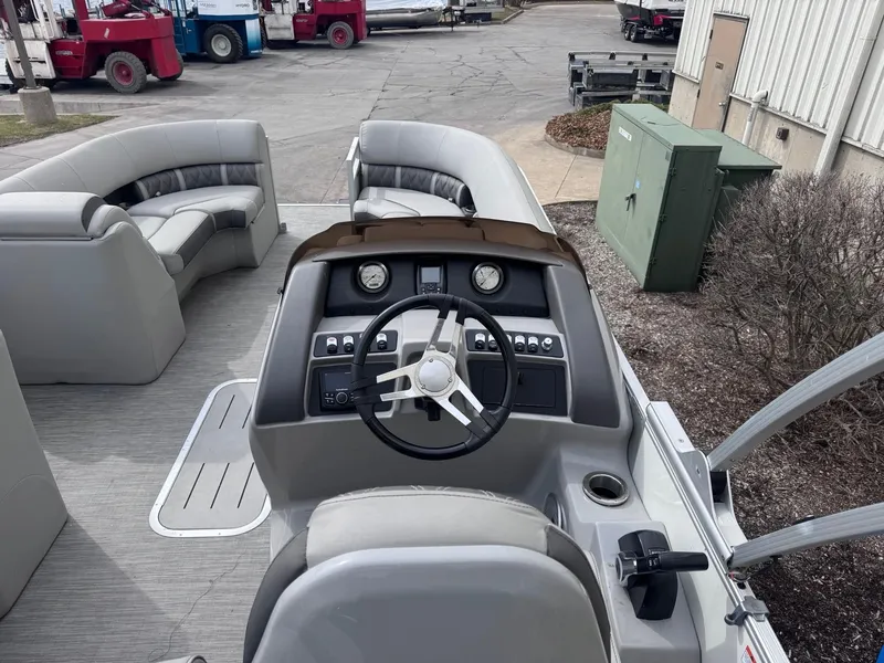 Slide: The Image of 2022 Bennington LX24FB pontoon boat interior with steering console and seating. - 8