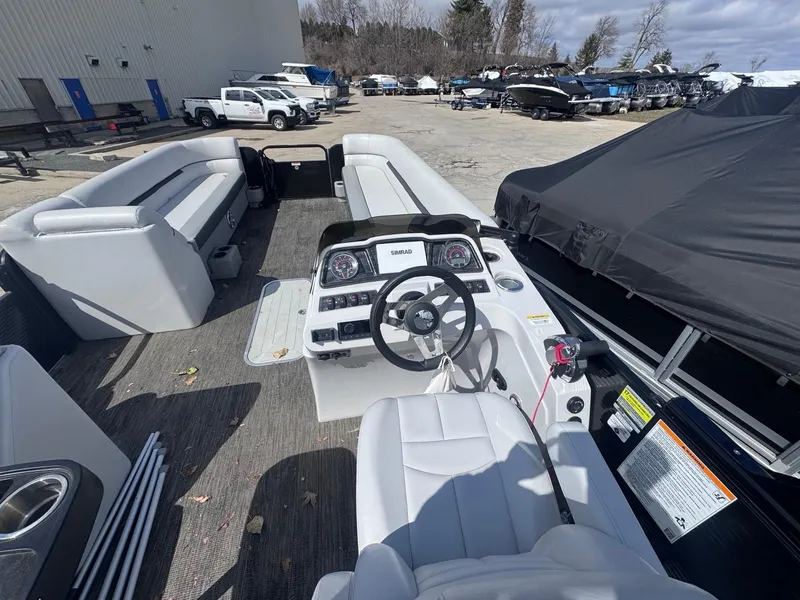 Slide: The Image of 2021 Sweetwater 2486SFL pontoon boat interior with steering console and seating. - 8
