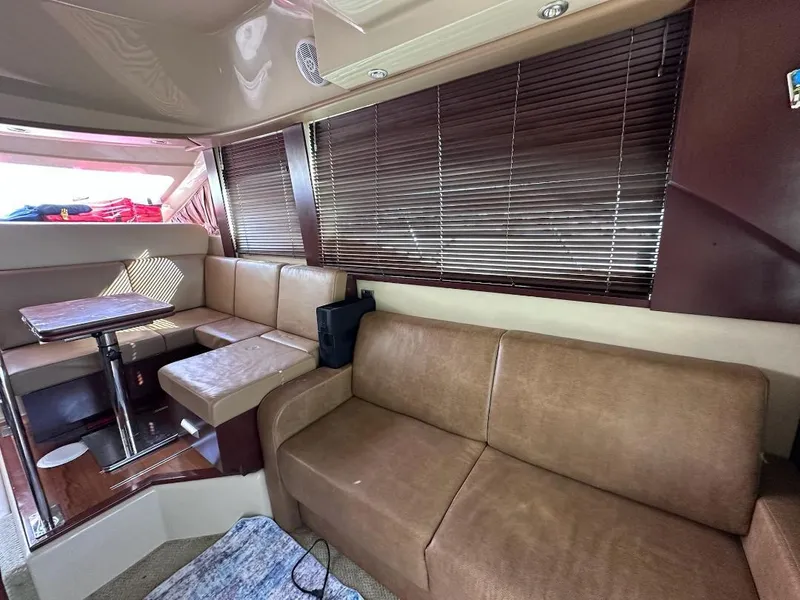 Slide: The Image of Interior of 2007 Sea Ray 360 Sedan Bridge with leather seating and wooden blinds. - 15