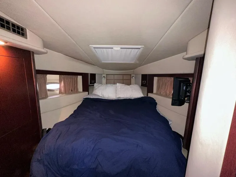Slide: The Image of Interior cabin of 2007 Sea Ray 360 Sedan Bridge with bed and portholes. - 18