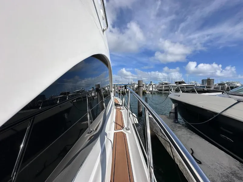 Slide: The Image of 2007 Sea Ray 360 Sedan Bridge yacht docked at marina under blue sky. - 3
