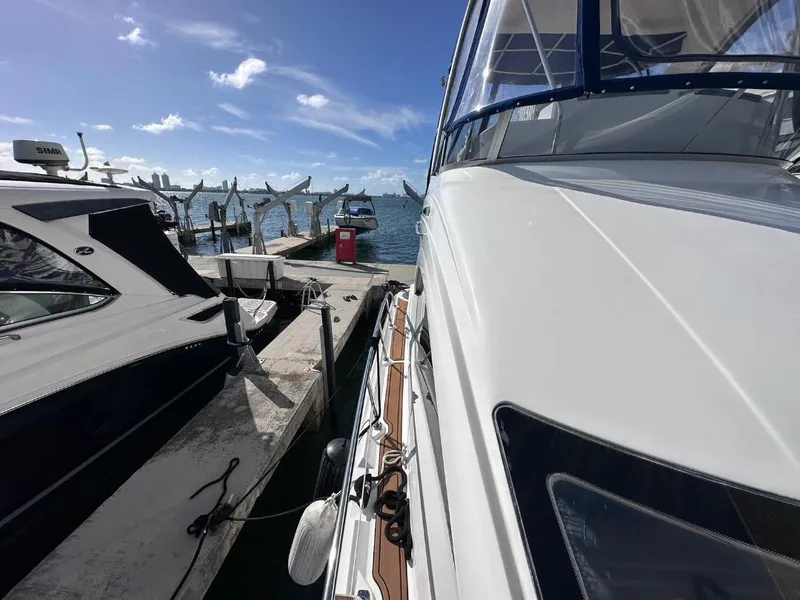 Slide: The Image of 2007 Sea Ray 360 Sedan Bridge yacht docked at marina under clear blue sky. - 4