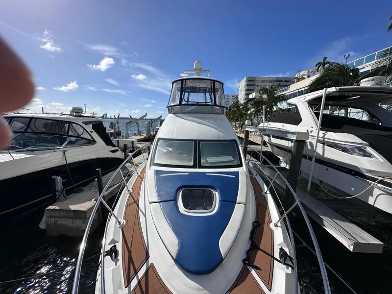 Slide: The Image of 2007 Sea Ray 360 Sedan Bridge yacht docked at marina under clear blue sky. - 5