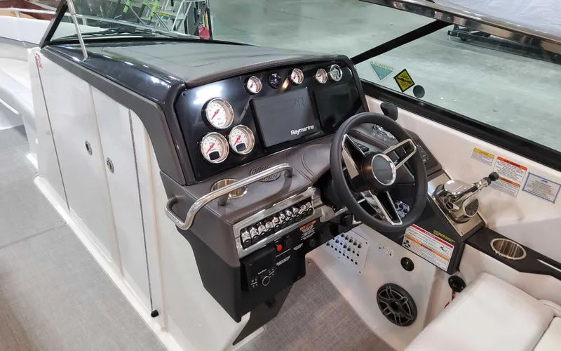 Slide: The Image of 2025 Formula 310 Bowrider dashboard with modern controls and steering wheel. - 15