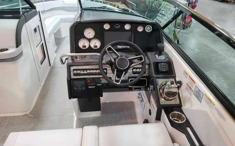 Slide: The Image of 2025 Formula 310 Bowrider dashboard with modern controls and steering wheel. - 16