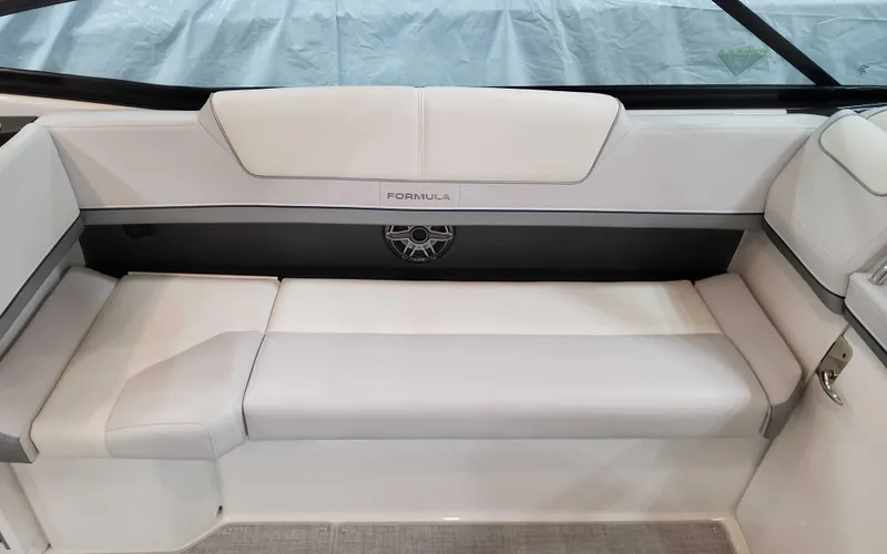 Slide: The Image of 2025 Formula 310 Bowrider interior seating with white upholstery and sleek design. - 17