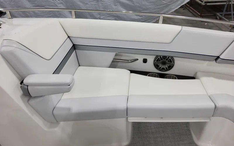 Slide: The Image of 2025 Formula 310 Bowrider interior seating with white upholstery and speaker detail. - 24