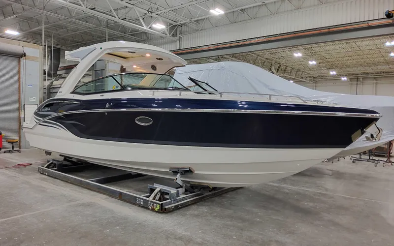 Slide: The Image of 2025 Formula 310 Bowrider boat in a showroom, showcasing sleek design and modern features. - 4