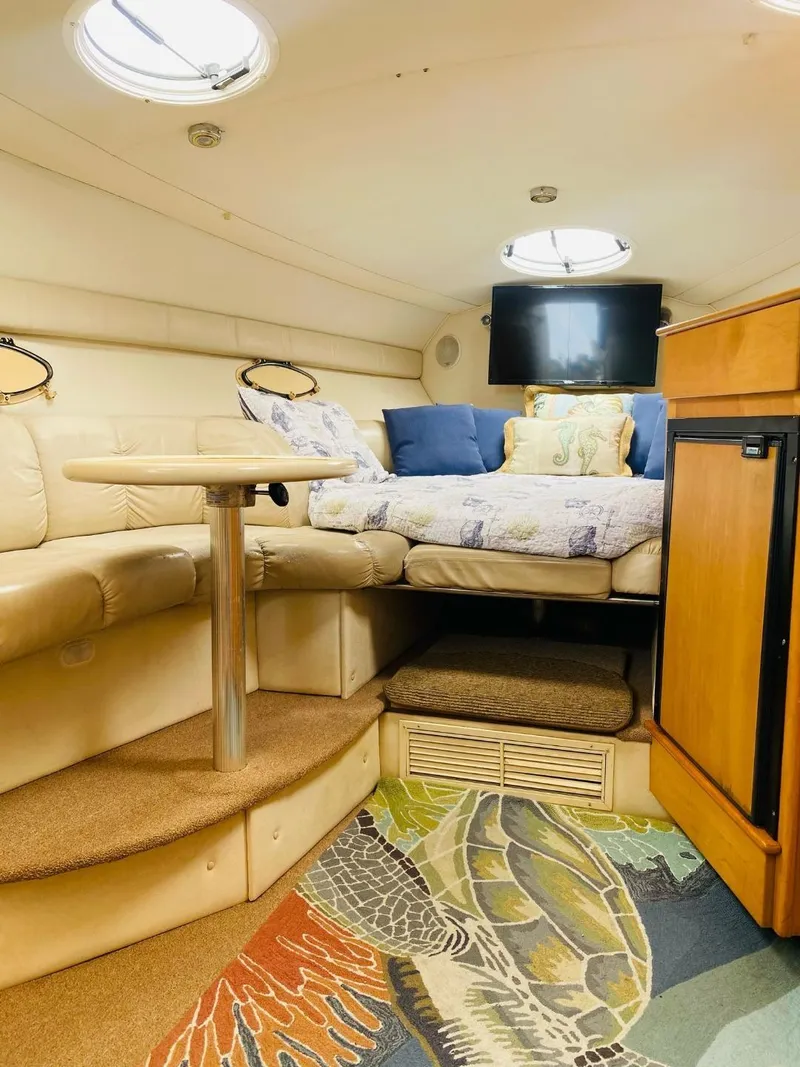 Slide: The Image of Interior of a 2003 Larson 310 boat with cozy seating and vibrant carpet. - 8