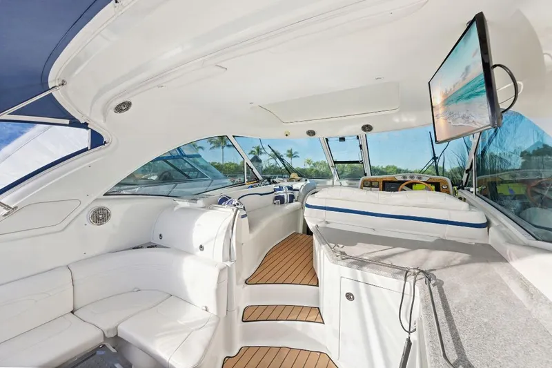 Slide: The Image of Luxurious interior of a 2007 Formula 45 Yacht with white seating and a mounted TV. - 10