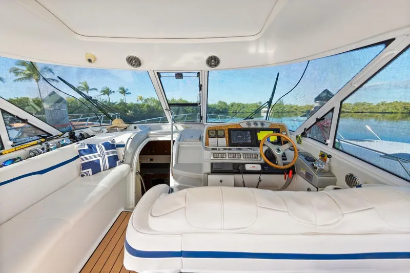 Slide: The Image of 2007 Formula 45 Yacht interior with helm, plush seating, and scenic water view. - 17