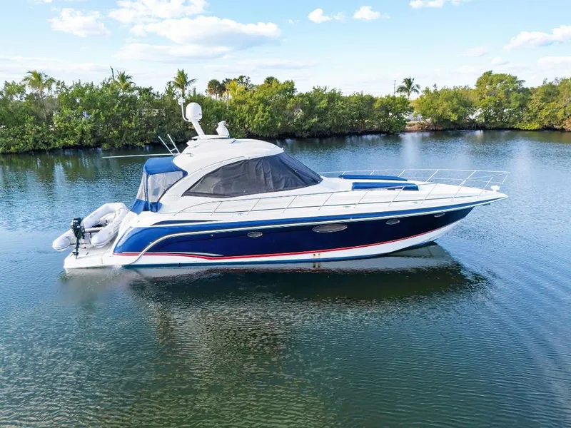 Slide: The Image of 2007 Formula 45 Yacht on calm water, surrounded by lush greenery and clear skies. - 2