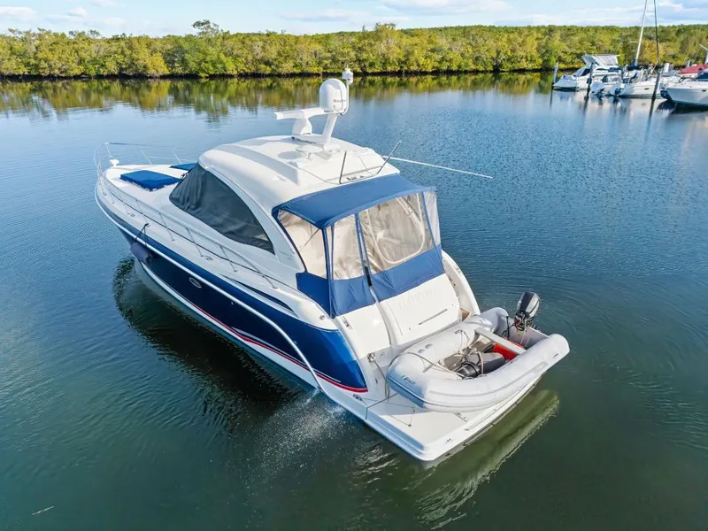 Slide: The Image of 2007 Formula 45 Yacht cruising on calm waters with inflatable boat attached. - 3