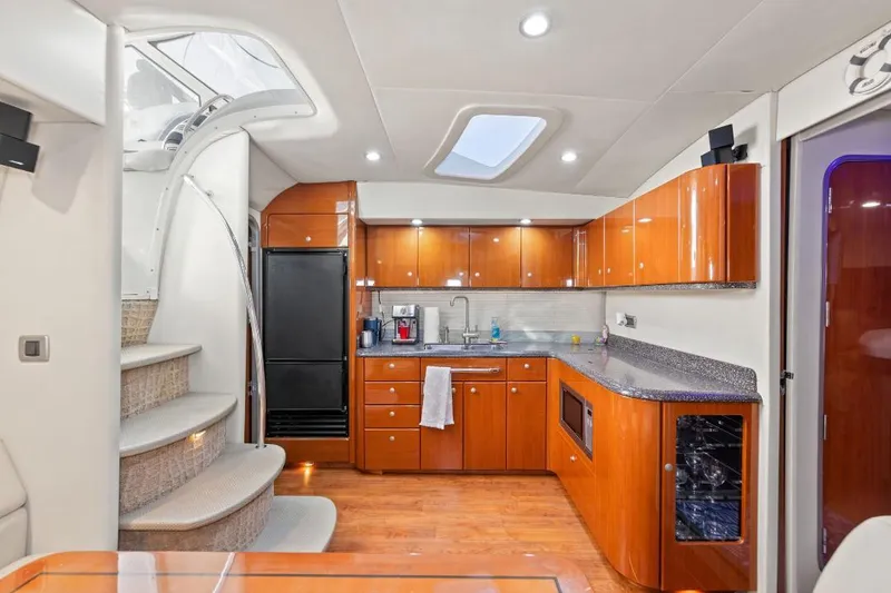Slide: The Image of Luxurious kitchen interior of a 2007 Formula 45 Yacht with wooden cabinetry and modern appliances. - 7