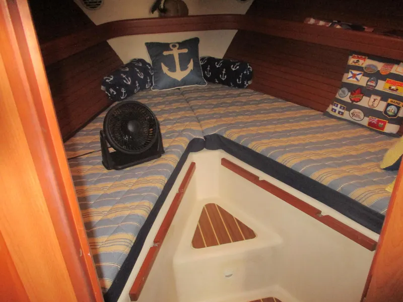 Slide: The Image of Cozy cabin interior of 2007 Mainship Pilot 34 Sedan with nautical-themed decor. - 15
