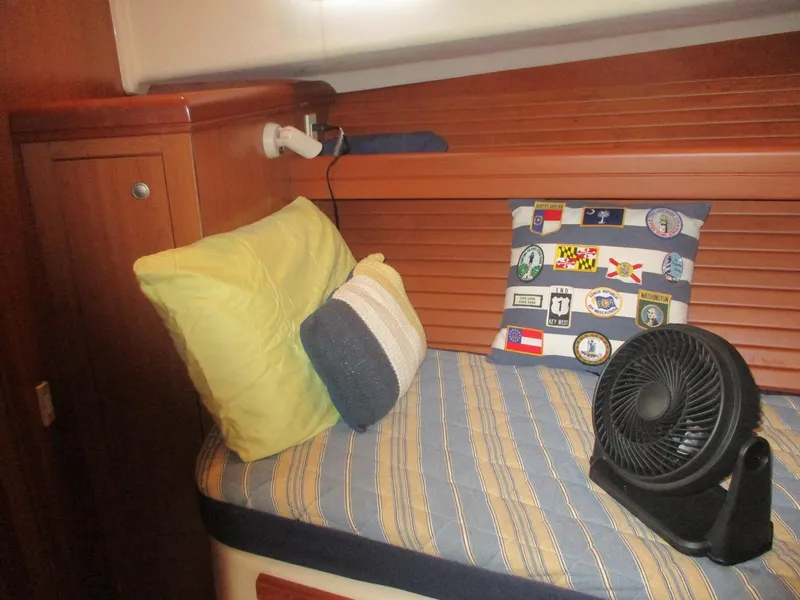 Slide: The Image of Cozy cabin interior of 2007 Mainship Pilot 34 Sedan with cushions and fan. - 17