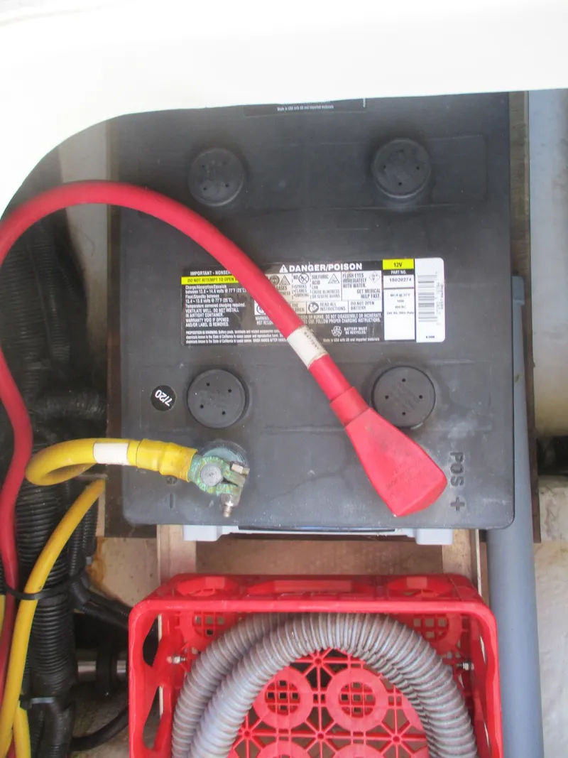 Slide: The Image of Battery compartment of 2007 Mainship Pilot 34 Sedan with cables and storage crate. - 21