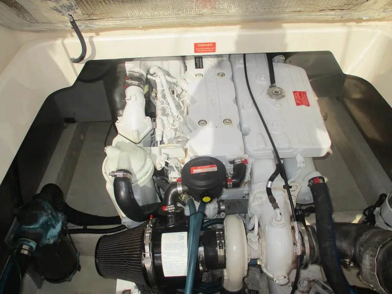 Slide: The Image of Engine compartment of a 2007 Mainship Pilot 34 Sedan boat, showcasing detailed machinery. - 24