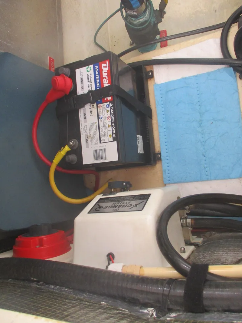 Slide: The Image of 2007 Mainship Pilot 34 Sedan engine compartment with battery and wiring. - 25