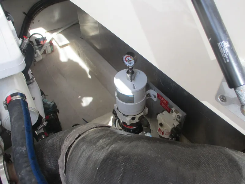 Slide: The Image of Engine compartment of 2007 Mainship Pilot 34 Sedan with visible components and hoses. - 27