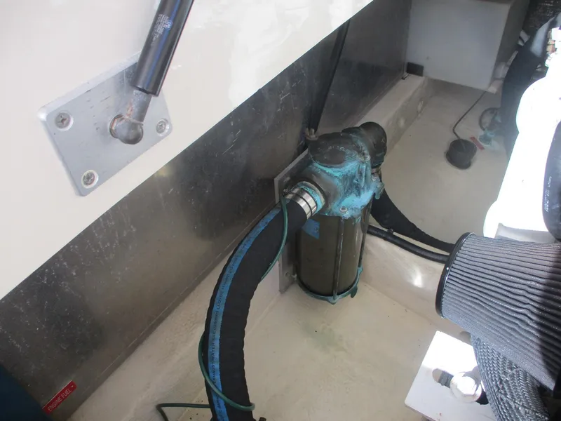 Slide: The Image of Engine compartment of 2007 Mainship Pilot 34 Sedan, showing hoses and mechanical components. - 28