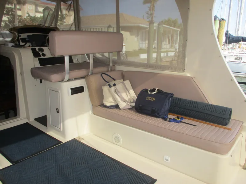 Slide: The Image of 2007 Mainship Pilot 34 Sedan interior with seating, bags, and nautical equipment. - 30
