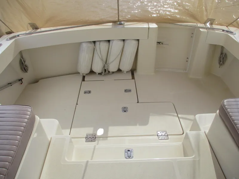 Slide: The Image of 2007 Mainship Pilot 34 Sedan boat deck with storage compartments and fenders. - 31