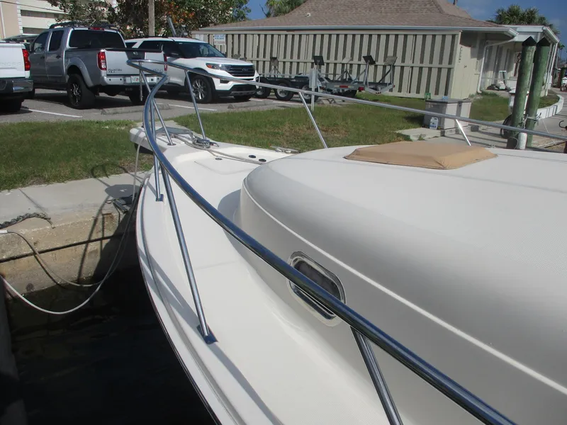 Slide: The Image of 2007 Mainship Pilot 34 Sedan docked, showcasing sleek design and sturdy railings. - 32
