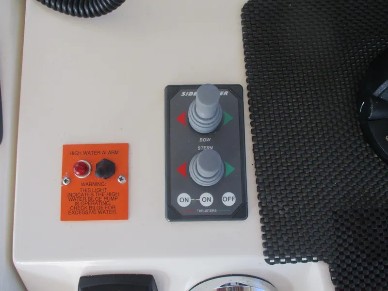 Slide: The Image of Control panel of a 2007 Mainship Pilot 34 Sedan with thruster and water alarm indicators. - 7