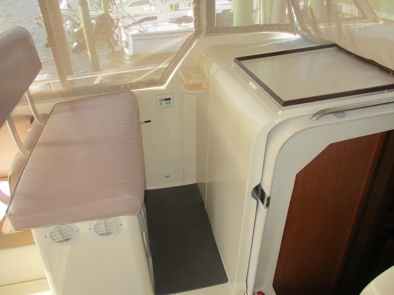 Slide: The Image of 2007 Mainship Pilot 34 Sedan interior with seating and storage area. - 8