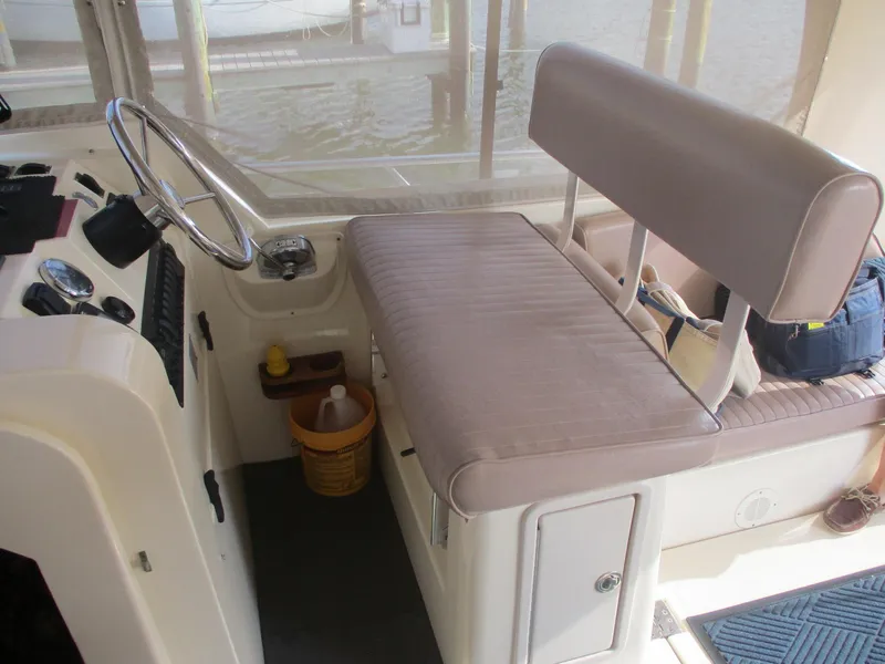 Slide: The Image of 2007 Mainship Pilot 34 Sedan helm with cushioned seating and steering wheel. - 9