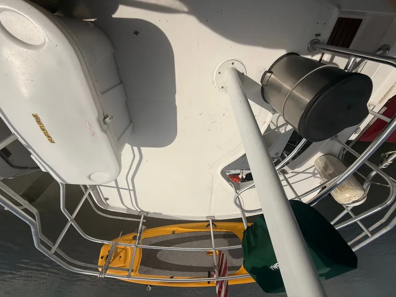 Slide: The Image of 2000 Mainship 390 Trawler deck with safety equipment and paddleboard. - 25