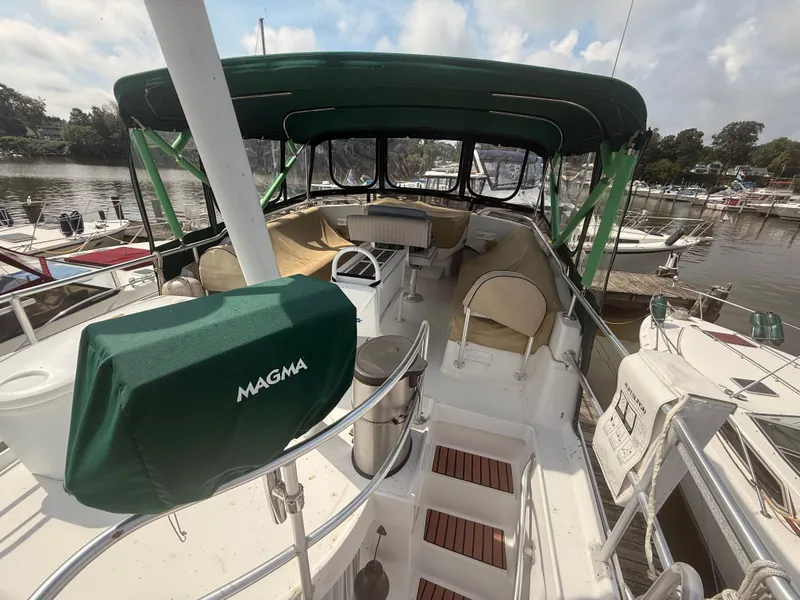Slide: The Image of 2000 Mainship 390 Trawler with green canopy, docked at marina. - 28