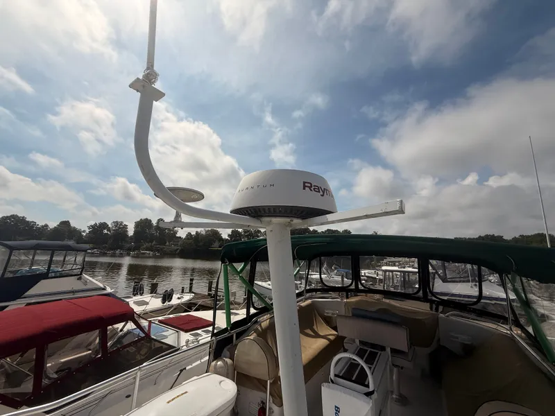 Slide: The Image of 2000 Mainship 390 Trawler with radar, docked under a partly cloudy sky. - 29
